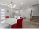 Open-concept dining and living area featuring modern lighting and staircase at 2702 Giardino Loop, Kissimmee, FL 34741