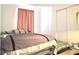 Bedroom with a comfortable bed, a closet with sliding doors, and soft natural light at 2711 Emerson Ln, Kissimmee, FL 34743