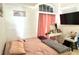Bedroom with TV, make up table, and large window, and a cozy sitting area at 2711 Emerson Ln, Kissimmee, FL 34743