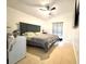 Cozy bedroom with tile flooring, ceiling fan and a comfortable bed setting at 2711 Emerson Ln, Kissimmee, FL 34743