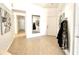 Inviting foyer with tile flooring, mirror and convenient coat rack near the front door at 2711 Emerson Ln, Kissimmee, FL 34743