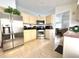 Well-equipped kitchen with stainless steel appliances, ample counter space, and tile flooring at 2711 Emerson Ln, Kissimmee, FL 34743
