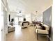 Bright and spacious living room featuring tile floors, a vaulted ceiling and stylish furniture at 2711 Emerson Ln, Kissimmee, FL 34743