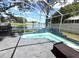 Pool and patio overlooking a serene pond, with seating for relaxation at 2711 Emerson Ln, Kissimmee, FL 34743