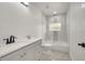 The main bathroom has tub, shower, large vanity with sink, tile surround, and stylish fixtures at 308 E Orange St, Kissimmee, FL 34744