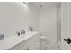 This bathroom features a white vanity and marble look tile in the shower at 308 E Orange St, Kissimmee, FL 34744