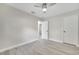 A bedroom offers hardwood floors, ceiling fan, and a closet with a white door at 308 E Orange St, Kissimmee, FL 34744