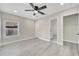 This bedroom features gray wood-look flooring, neutral paint and a ceiling fan at 308 E Orange St, Kissimmee, FL 34744