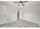 This bedroom features gray wood-look flooring, a ceiling fan and neutral paint at 308 E Orange St, Kissimmee, FL 34744