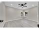 Bedroom with a ceiling fan, neutral paint and modern flooring at 308 E Orange St, Kissimmee, FL 34744