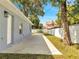 Long concrete driveway with grassy area and a wood fence in the background at 308 E Orange St, Kissimmee, FL 34744