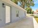 Long concrete driveway leading to the rear of the property. Light blue exterior at 308 E Orange St, Kissimmee, FL 34744