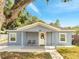 Charming single-story home with a covered front porch and a light blue exterior at 308 E Orange St, Kissimmee, FL 34744