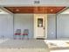 Inviting front porch with seating, a 'Welcome' mat, and a wood-paneled ceiling at 308 E Orange St, Kissimmee, FL 34744