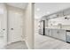 A partial view of the updated kitchen from the hallway with stainless appliances and grey cabinets at 308 E Orange St, Kissimmee, FL 34744