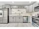 An updated kitchen offers stainless appliances, grey cabinets, and plenty of quartz counter space at 308 E Orange St, Kissimmee, FL 34744