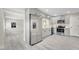 Open concept kitchen features stainless steel appliances, gray cabinets and a view to the living room at 308 E Orange St, Kissimmee, FL 34744