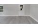 The living room features gray wood-look flooring, white trim, and a decorative front door at 308 E Orange St, Kissimmee, FL 34744