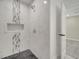 This shower features a gray and white marble-look tile and a corner shower niche at 308 E Orange St, Kissimmee, FL 34744