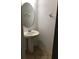 Half bathroom with pedestal sink, tile floors and white walls at 3319 Rodrick Cir, Orlando, FL 32824