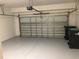View of an empty two car garage with an automatic door opener at 3319 Rodrick Cir, Orlando, FL 32824
