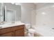 Bathroom featuring a vanity with dark wood cabinets and a tub/shower combo with white tile surround at 3589 Cortland Dr, Davenport, FL 33837