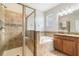 Luxurious bathroom featuring separate shower, bathtub, and granite countertops at 3589 Cortland Dr, Davenport, FL 33837