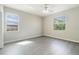 Bright bedroom with a ceiling fan, hardwood floors, and two windows providing ample natural light at 3589 Cortland Dr, Davenport, FL 33837