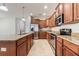 Well-equipped kitchen with granite counters, wooden cabinetry, and stainless-steel appliances at 3589 Cortland Dr, Davenport, FL 33837