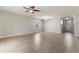 Spacious living room with ceiling fan and ample natural light from the large window at 3589 Cortland Dr, Davenport, FL 33837