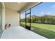 A screened patio overlooking a spacious, fenced backyard and well-maintained lawn, perfect for outdoor living at 3589 Cortland Dr, Davenport, FL 33837
