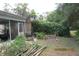 View of the backyard with plants and a brick outdoor cooking area at 386 San Jose Dr, Winter Haven, FL 33884