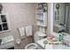 Cozy bathroom featuring floral wallpaper, white fixtures, and decorative accents for a vintage aesthetic at 386 San Jose Dr, Winter Haven, FL 33884