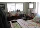 Bedroom with flowered bedspread, desk, chair, and view to the porch at 386 San Jose Dr, Winter Haven, FL 33884