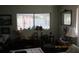 Bedroom with desk, chairs, lamps, and view to the screened porch at 386 San Jose Dr, Winter Haven, FL 33884
