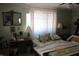 Cozy bedroom features a comfortable bed, dresser, and ample natural light from the window at 386 San Jose Dr, Winter Haven, FL 33884