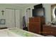 Bedroom with a TV, dresser, bed, painting, and bi-fold closet doors at 386 San Jose Dr, Winter Haven, FL 33884