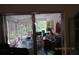 Relaxing screened porch with outdoor seating and views of the surrounding greenery, perfect for leisure at 386 San Jose Dr, Winter Haven, FL 33884
