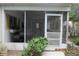 Enclosed screened porch featuring a grill and outdoor shutters at 386 San Jose Dr, Winter Haven, FL 33884