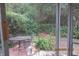 A screened porch showcases backyard views of patio, plants, and landscaping at 386 San Jose Dr, Winter Haven, FL 33884