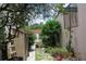 An exterior side yard offers both plants and a shed at 386 San Jose Dr, Winter Haven, FL 33884