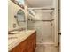 Bathroom featuring a double sink vanity with granite countertop, a glass-enclosed shower, and tile flooring at 421 Bailey Cir, Davenport, FL 33897