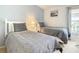 Bright bedroom featuring two twin beds with stylish chevron bedding and a serene coastal-themed painting at 421 Bailey Cir, Davenport, FL 33897