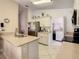 Bright kitchen with stainless steel appliances, white cabinets, and an island workspace at 421 Bailey Cir, Davenport, FL 33897
