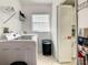 Practical laundry room featuring modern washer and dryer, storage shelves, and tile flooring at 421 Bailey Cir, Davenport, FL 33897