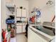 Functional laundry room with cabinets, wire shelving, counter space and modern washer and dryer at 421 Bailey Cir, Davenport, FL 33897