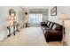 Bright living room featuring a plush brown sofa, neutral walls and stylish decor with natural light at 421 Bailey Cir, Davenport, FL 33897