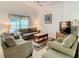 Comfortable living room with neutral furniture, ceiling fan, and bright window offering natural light at 421 Bailey Cir, Davenport, FL 33897