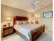 Cozy bedroom with a large bed, ceiling fan, and ensuite bathroom, illuminated by bedside lamps at 421 Bailey Cir, Davenport, FL 33897