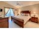 Relaxing bedroom with a large bed, ceiling fan, and natural light from a window, with two bedside tables at 421 Bailey Cir, Davenport, FL 33897